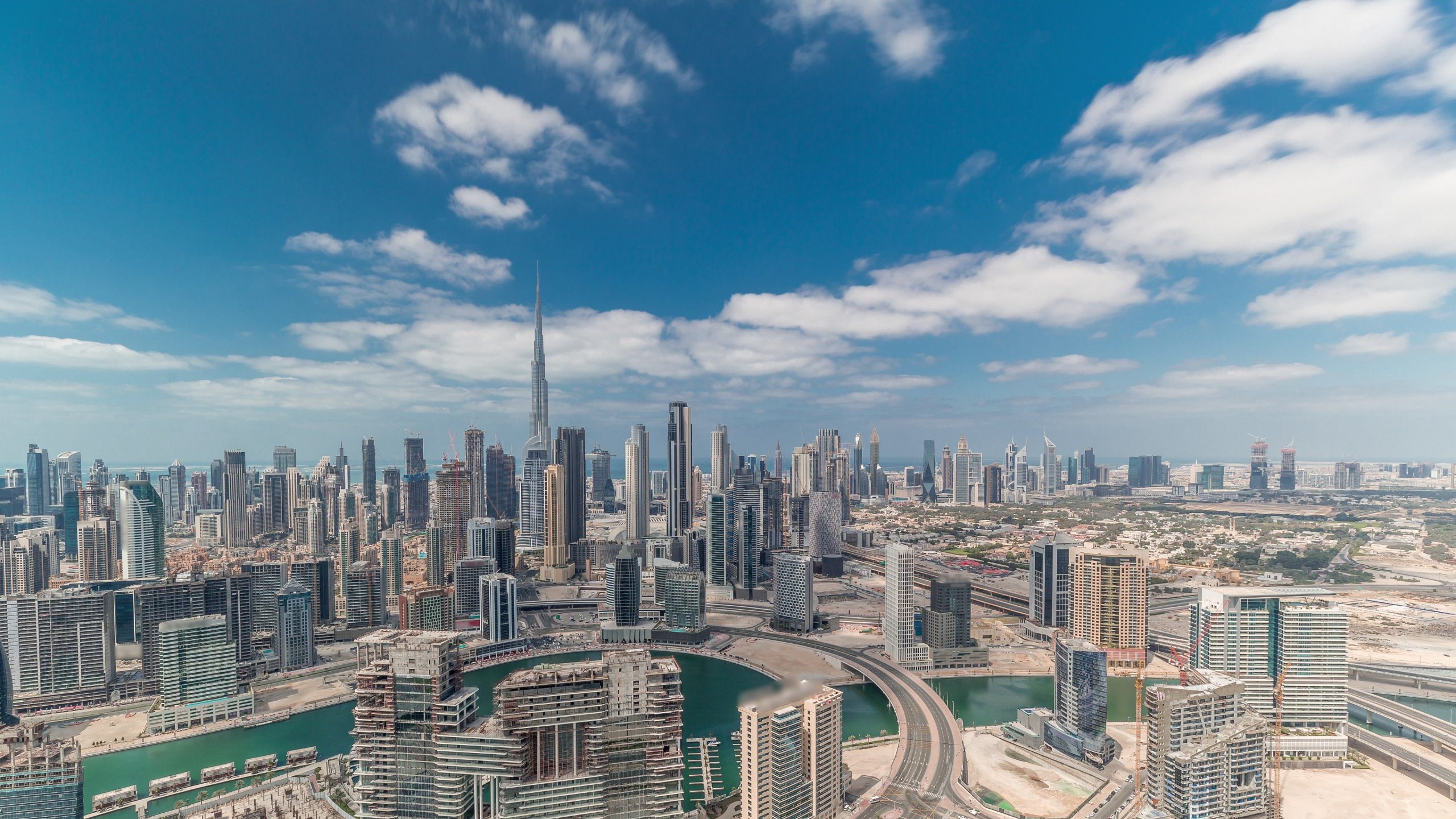 Aerial view of Dubai's skyline from Burj Khalifa, featuring prominent commercial real estate and modern buildings.